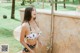 A woman in a black and white polka dot bikini standing in a shower.