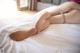 A woman laying on a bed with her legs crossed.